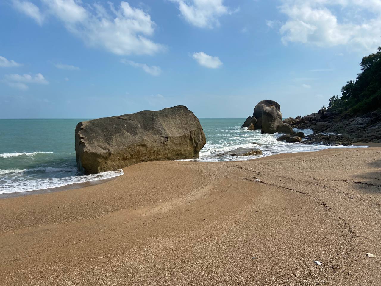 Secluded Haad Nam Tok Beach with serene surroundings and natural beauty on Koh Phangan.