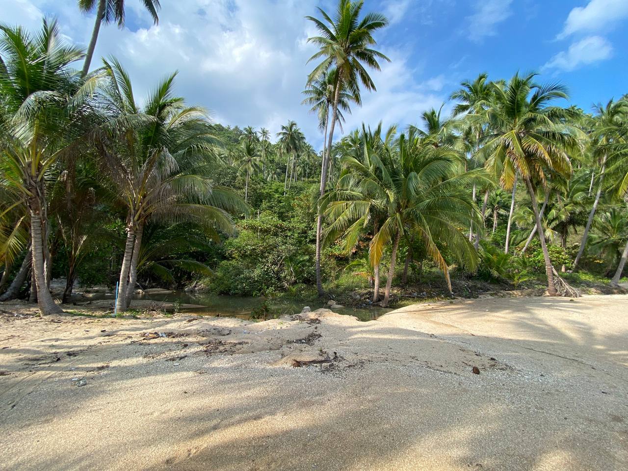 Secluded Haad Nam Tok Beach with serene surroundings and natural beauty on Koh Phangan.