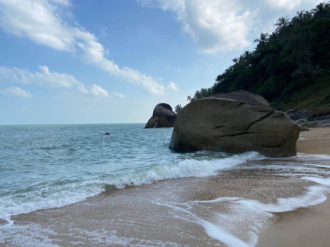 Secluded Haad Nam Tok Beach with serene surroundings and natural beauty on Koh Phangan.