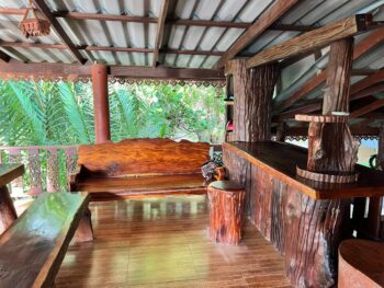 Dining area at Wang Sai Restaurant near the beach, serving Thai food, pizzas, and spaghetti.