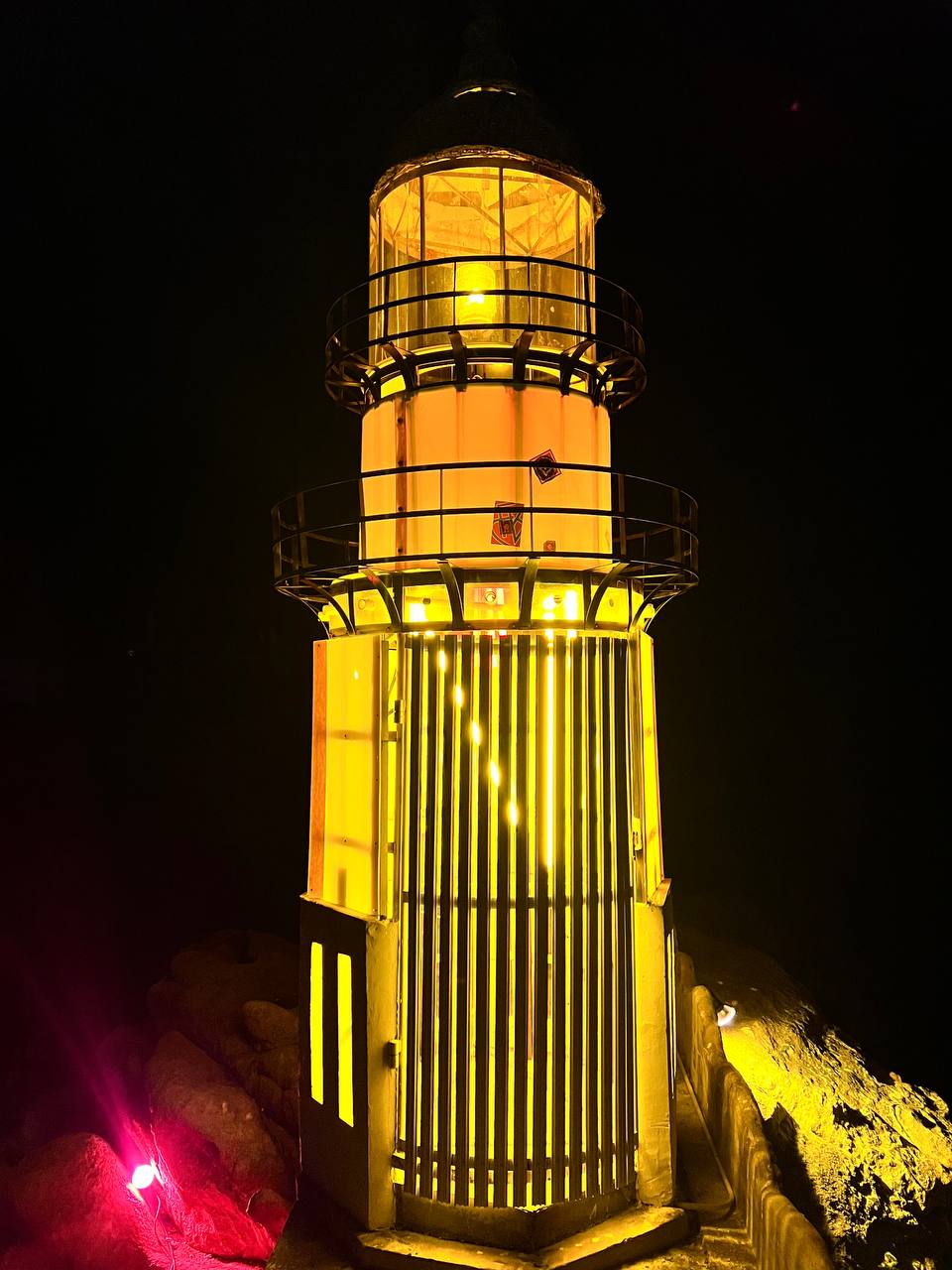 Lighthouse party at night with people dancing under the stars on Koh Phangan