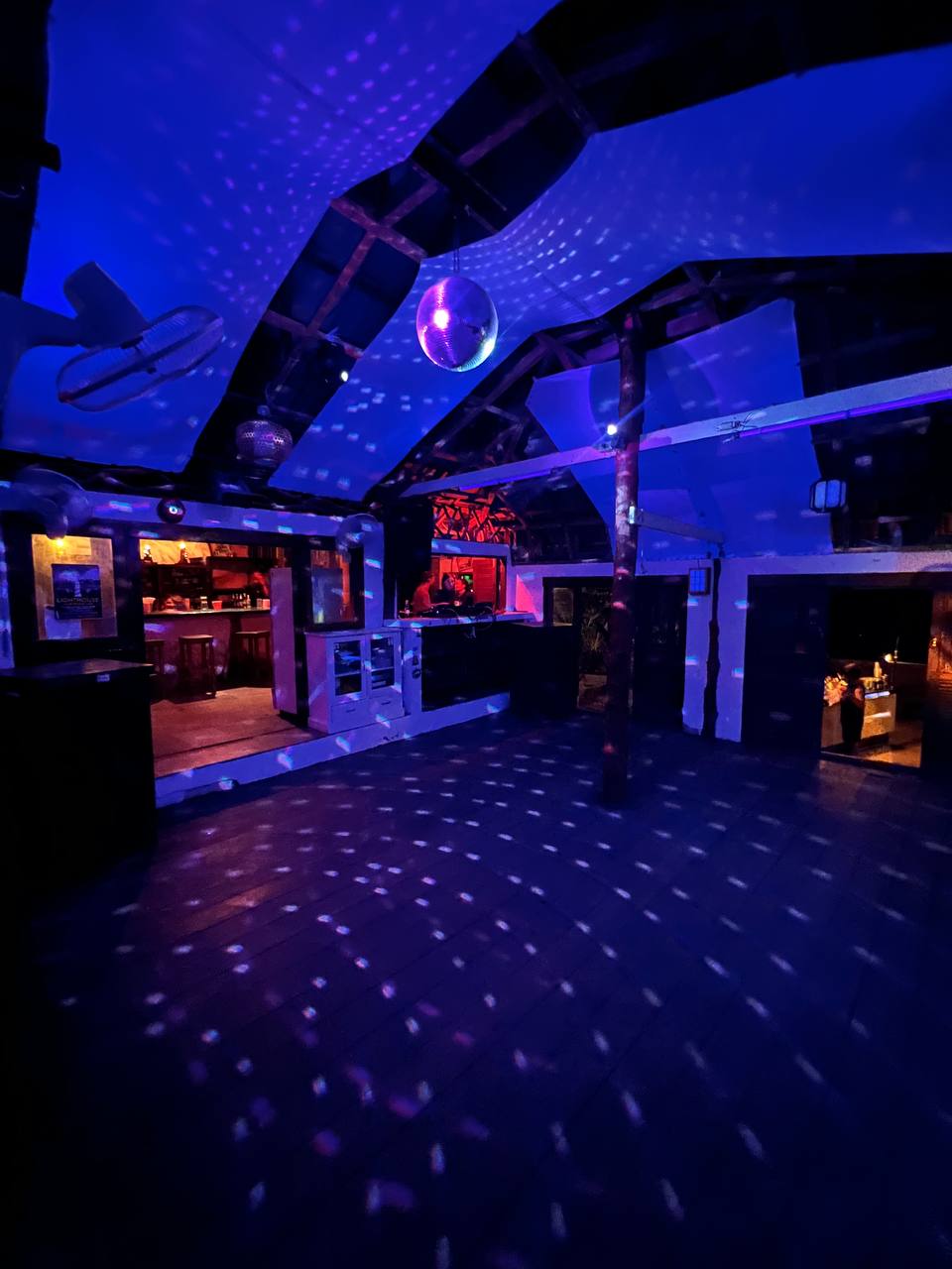 Lighthouse party at night with people dancing under the stars on Koh Phangan