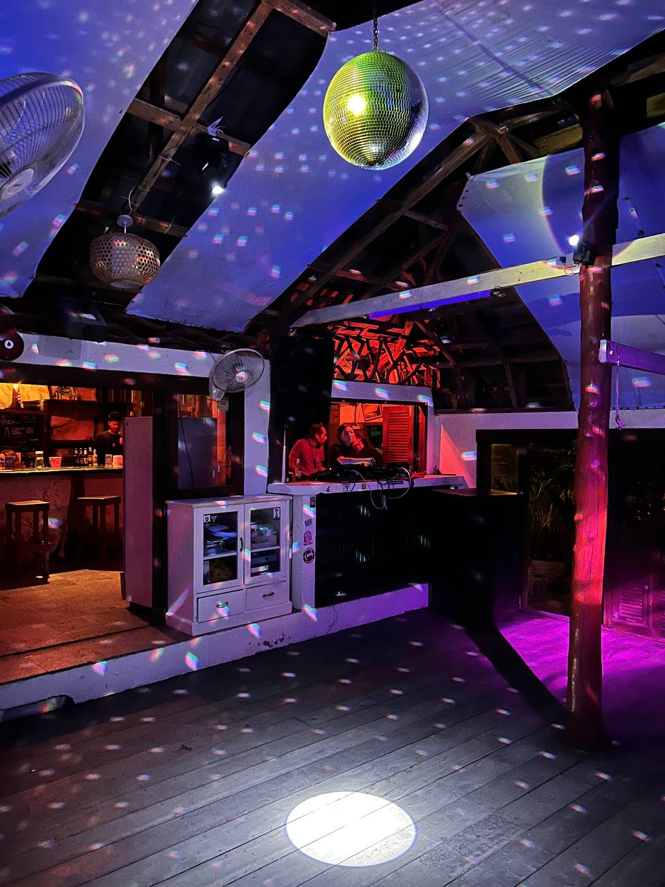 Lighthouse party at night with people dancing under the stars on Koh Phangan