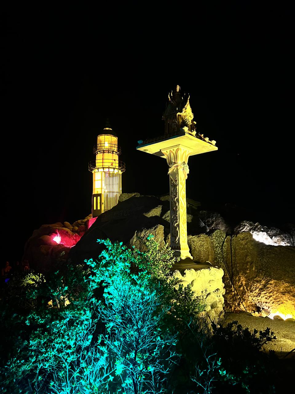 Lighthouse party at night with people dancing under the stars on Koh Phangan