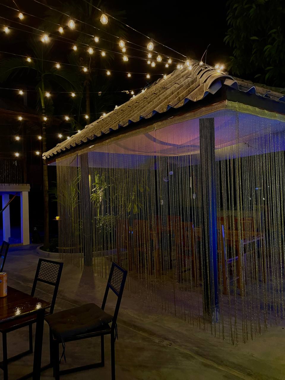 Joka Lounge Bar interior with lounge seating, projector screen, and cozy lighting