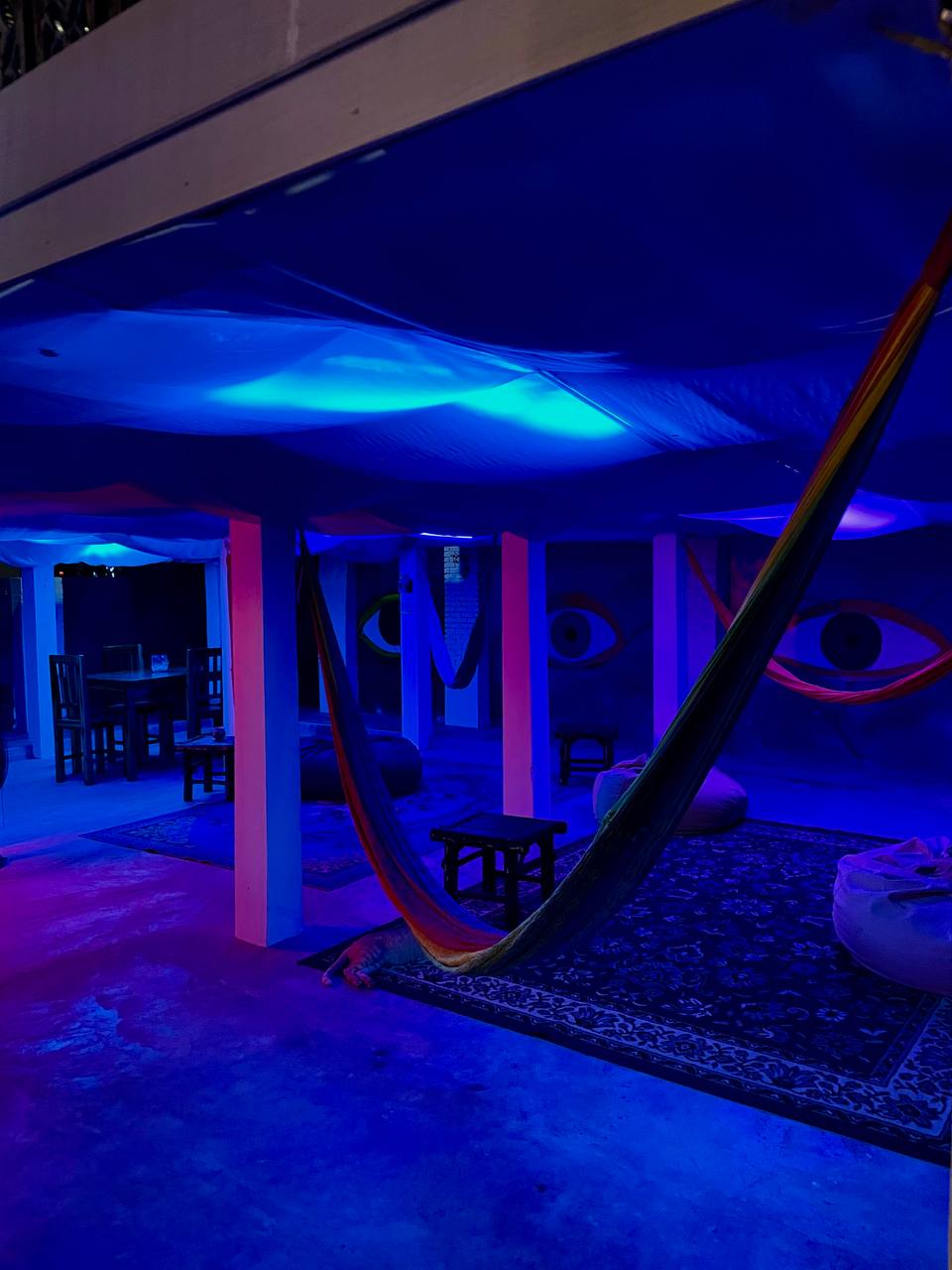 Joka Lounge Bar interior with lounge seating, projector screen, and cozy lighting