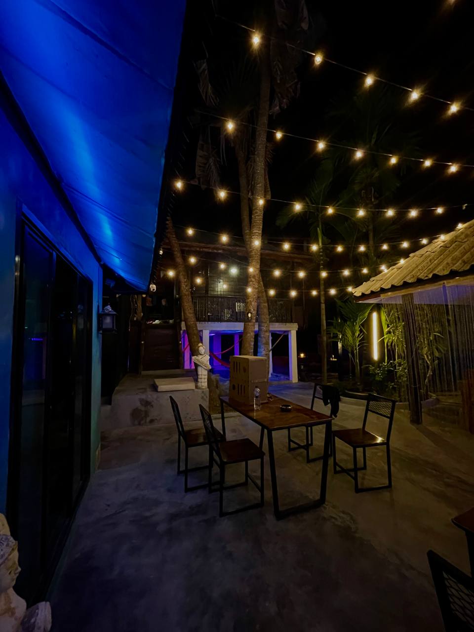 Joka Lounge Bar interior with lounge seating, projector screen, and cozy lighting