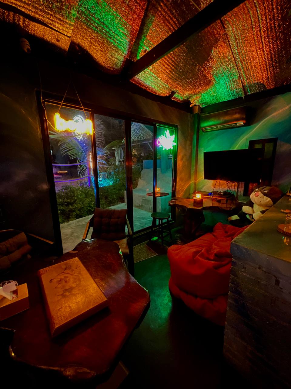Joka Lounge Bar interior with lounge seating, projector screen, and cozy lighting