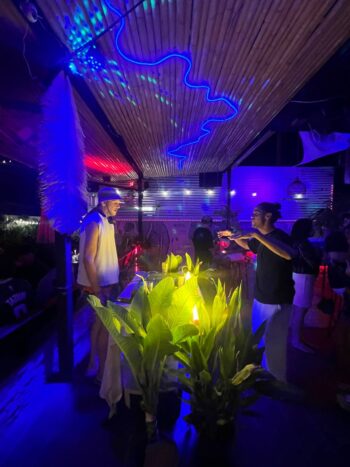 Le Club Bar interior with cozy seating, board games, and chill island ambiance