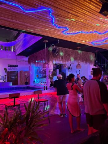 Le Club Bar interior with cozy seating, board games, and chill island ambiance