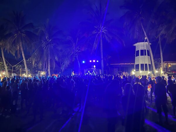 Full Moon Party on Koh Phangan at Haad Rin Beach with neon lights, beach crowd, DJs, and fire show