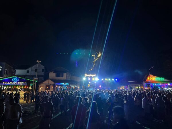 Full Moon Party on Koh Phangan at Haad Rin Beach with neon lights, beach crowd, DJs, and fire show