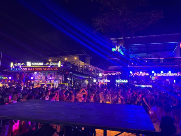 Full Moon Party on Koh Phangan at Haad Rin Beach with neon lights, beach crowd, DJs, and fire show