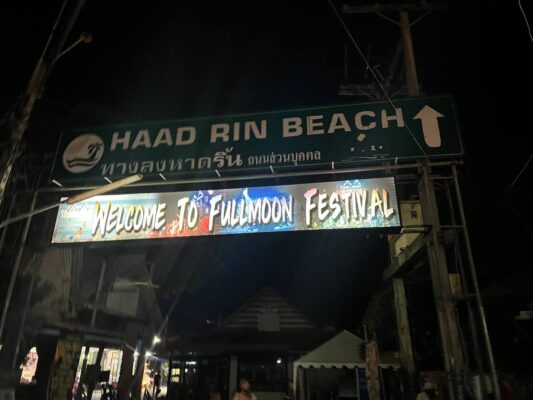Full Moon Party on Koh Phangan at Haad Rin Beach with neon lights, beach crowd, DJs, and fire show