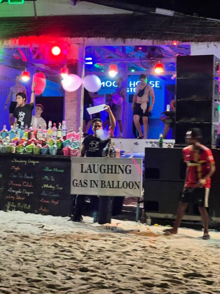 Full Moon Party on Koh Phangan at Haad Rin Beach with neon lights, beach crowd, DJs, and fire show