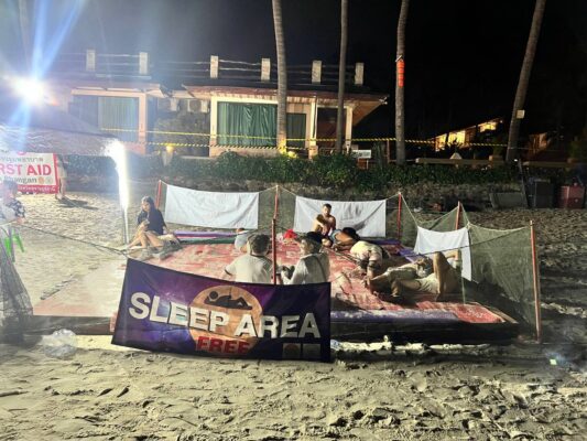 Full Moon Party on Koh Phangan at Haad Rin Beach with neon lights, beach crowd, DJs, and fire show