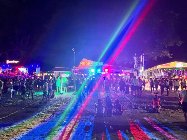 Full Moon Party on Koh Phangan at Haad Rin Beach with neon lights, beach crowd, DJs, and fire show