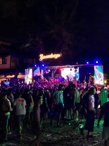Full Moon Party on Koh Phangan at Haad Rin Beach with neon lights, beach crowd, DJs, and fire show