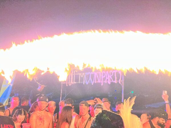 Full Moon Party on Koh Phangan at Haad Rin Beach with neon lights, beach crowd, DJs, and fire show