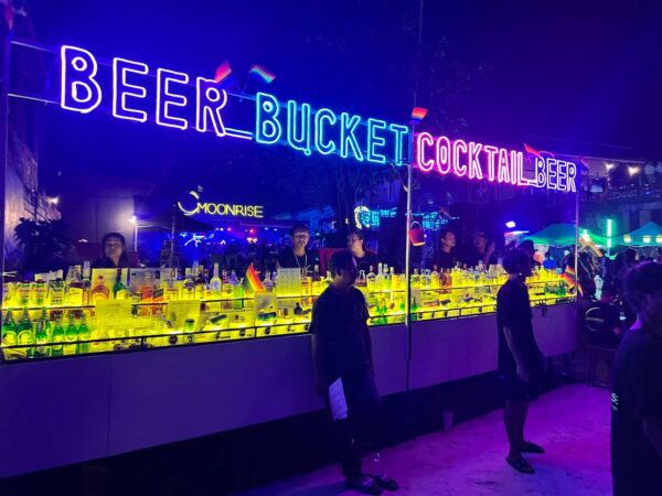 Full Moon Party on Koh Phangan at Haad Rin Beach with neon lights, beach crowd, DJs, and fire show