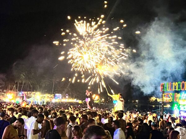 Full Moon Party on Koh Phangan at Haad Rin Beach with neon lights, beach crowd, DJs, and fire show
