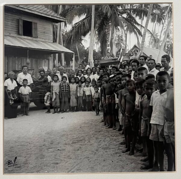 Large gathering of local residents and children on Koh Phangan in a historical photograph