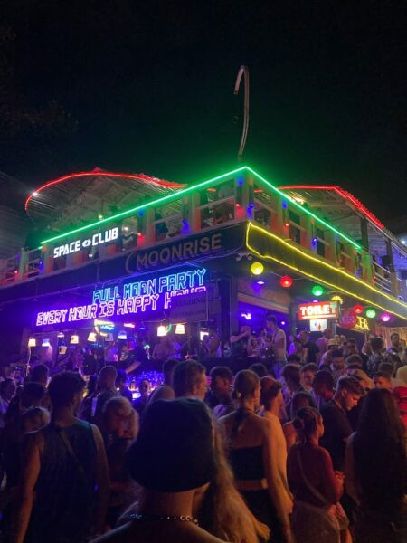 Full Moon Party on Koh Phangan at Haad Rin Beach with neon lights, beach crowd, DJs, and fire show