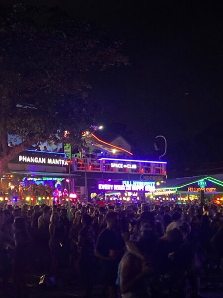 Full Moon Party on Koh Phangan at Haad Rin Beach with neon lights, beach crowd, DJs, and fire show