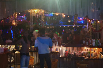 Vibrant nightlife at Hollystone, Koh Phangan with a dance floor, food, cocktails, and DJs in a jungle setting.